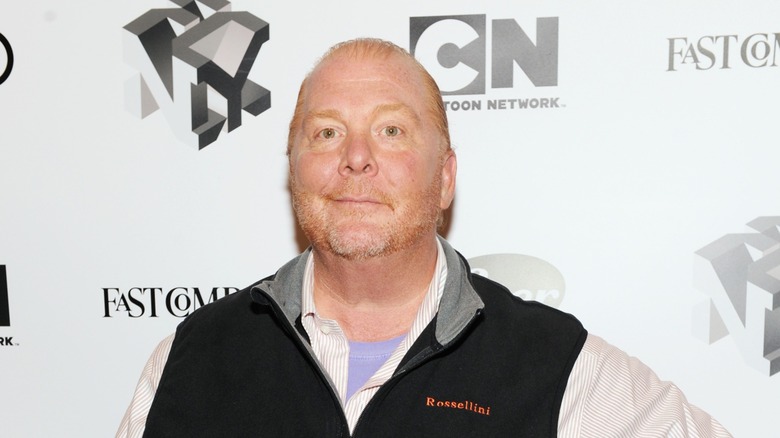 Mario Batali looking toward the camera at a red carpet event