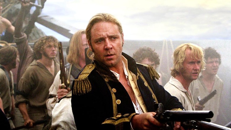 Russell Crowe as Jack Aubrey, aiming guns on a ship in Master and Commander: The Far Side of the World.
