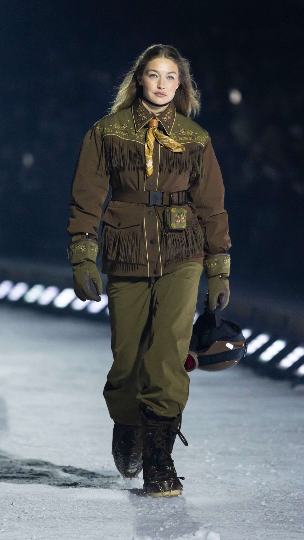 model walking on a runway wearing a unique winter outfit