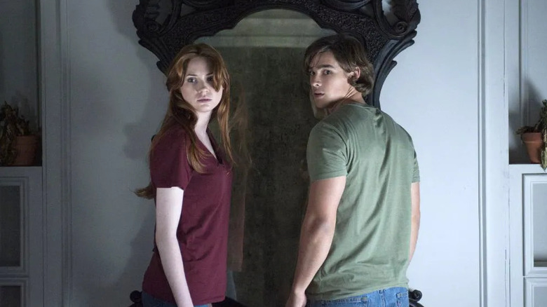 Kaylie and Tim standing in front of the mirror in 