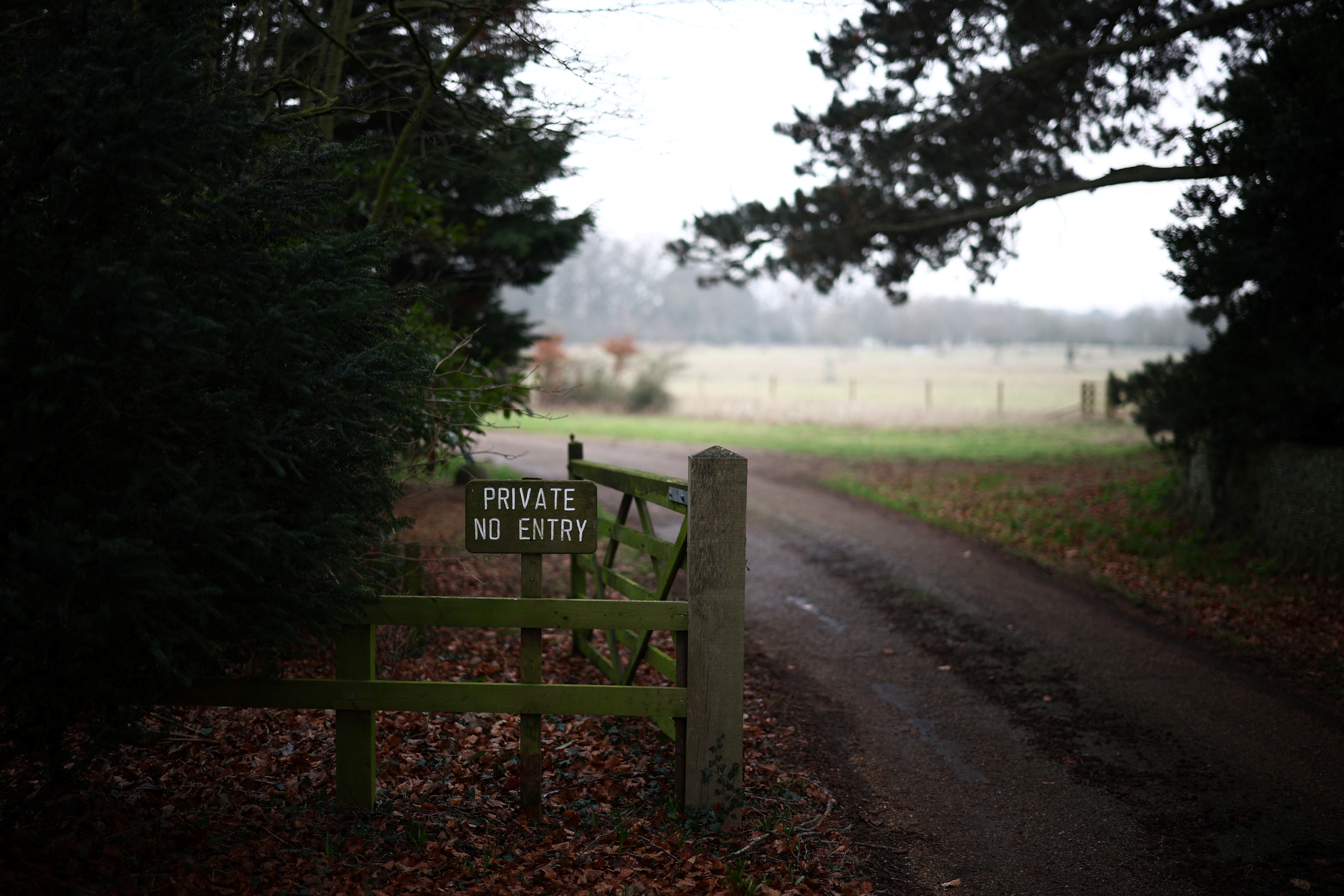 A wooden fence with a private sign at the entrance to Wood Farm