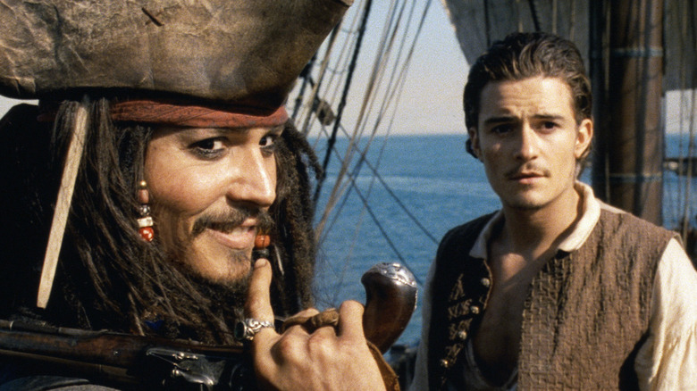 Johnny Depp as Jack Sparrow and Orlando Bloom as Will Turner in Pirates of the Caribbean: The Curse of the Black Pearl.