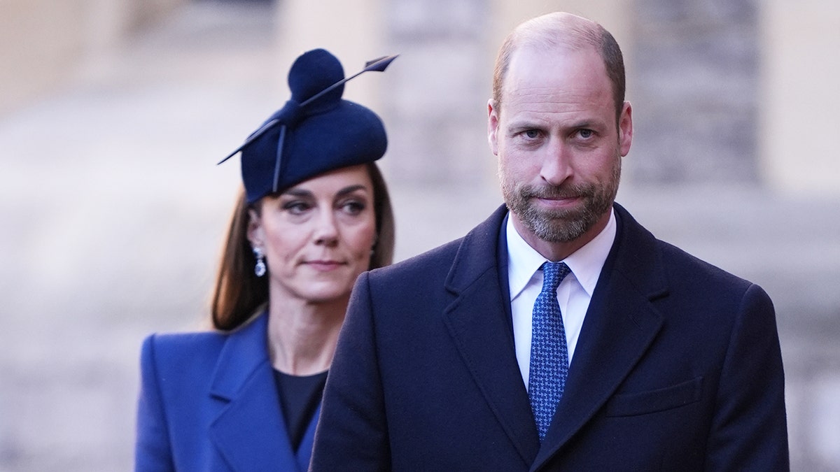Prince William walking ahead of Princess Catherine as they wear matching royal blue ensembles.