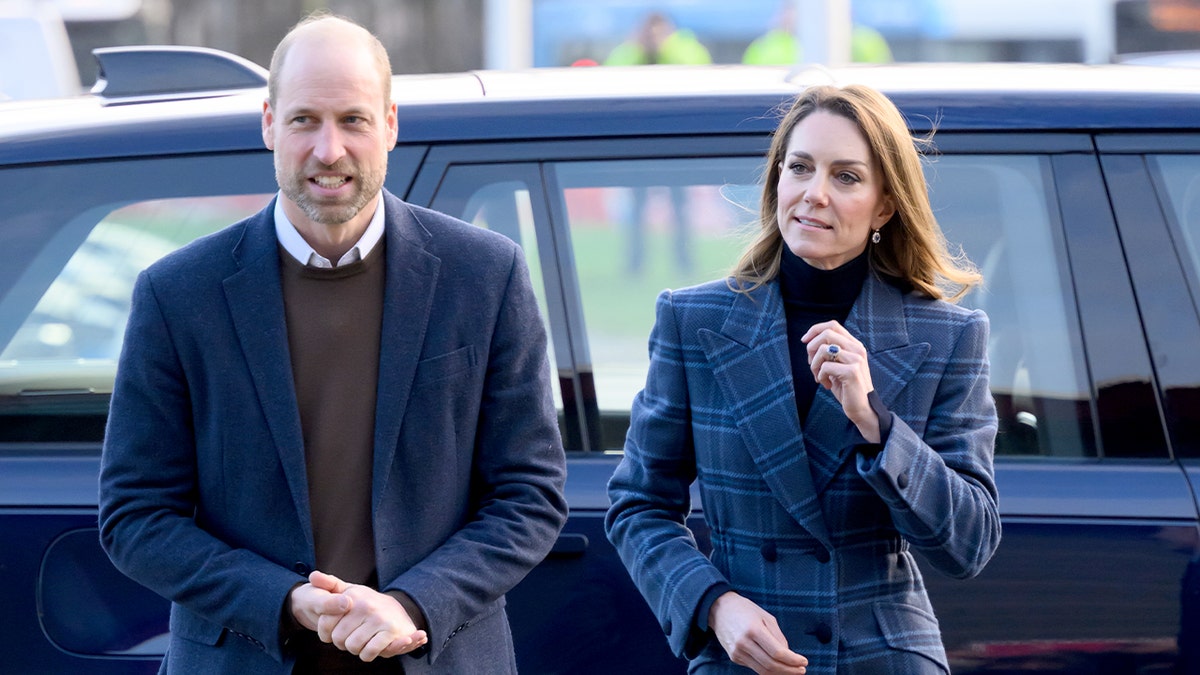 The Prince and Princess of Wales walk together toward a sports venue during an official engagement in Scotland.