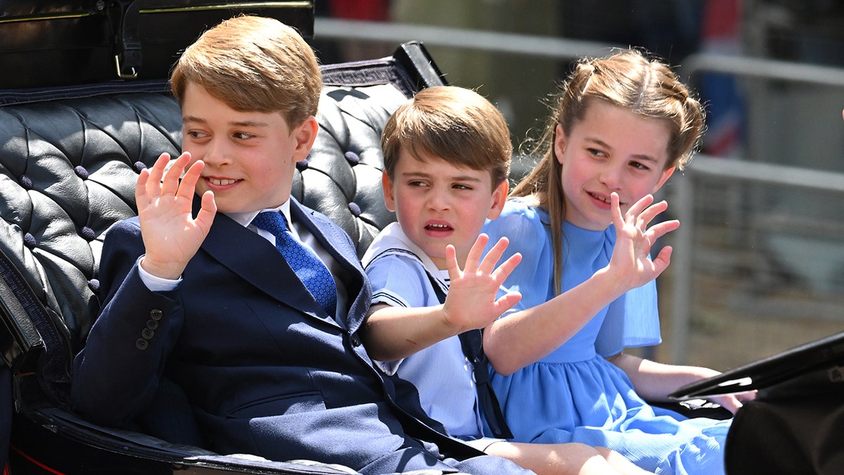 George, Charlotte and Louis wave during Trooping the Colour