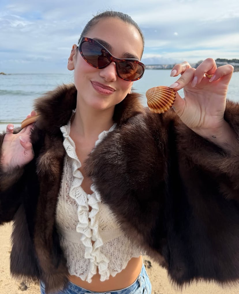 Dua Lipa wore a sheer top and slinky LBD on her latest vacation.