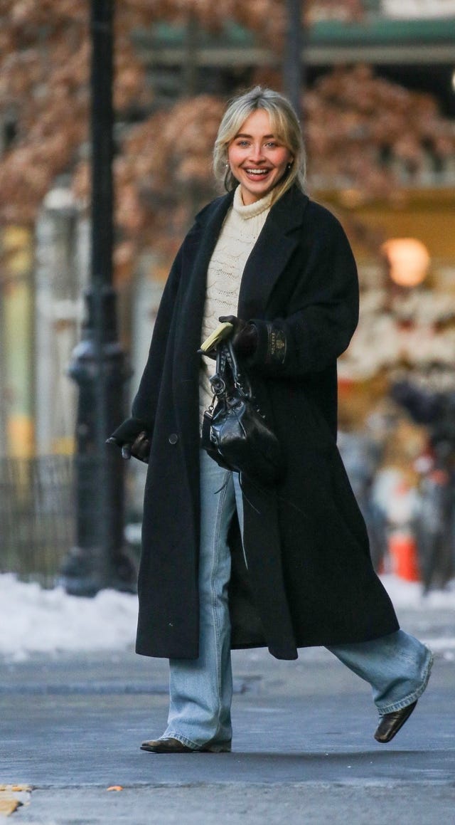 person walking on a city street in winter attire