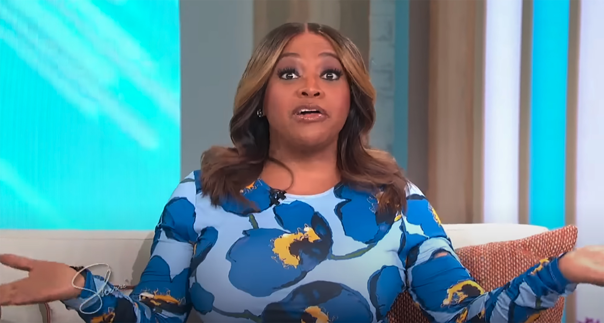Sherri Shepherd on a talk show, looking surprised or apologetic with her hands open.