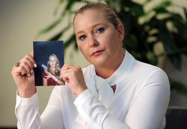 Virginia Roberts Giuffre, with a photo of herself as a teen, when she says she was abused by Jeffrey Epstein, Ghislaine Maxwell and Prince Andrew, among others. (Emily Michot/Miami Herald/TNS)