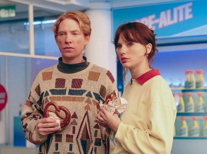 two individuals holding food in a commercial setting