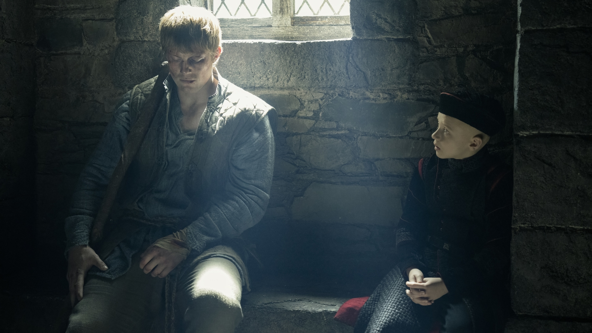 L-R: Dunk (Peter Claffey) and Egg (Dexter Sol Ansell) sitting in a stone room in a scene from "A Knight of the Seven Kingdoms" episode 6