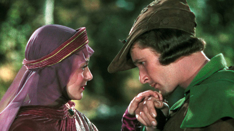 Errol Flynn as Robin Hood and Olivia de Havilland as Maid Marian, looking into each others eyes in The Adventures of Robinhood.