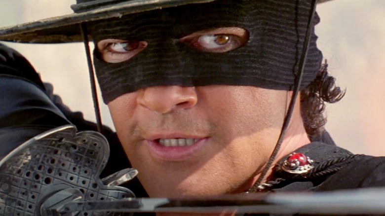 Antonio Banderas as Zorro, aiming his sword in The Mask of Zorro.