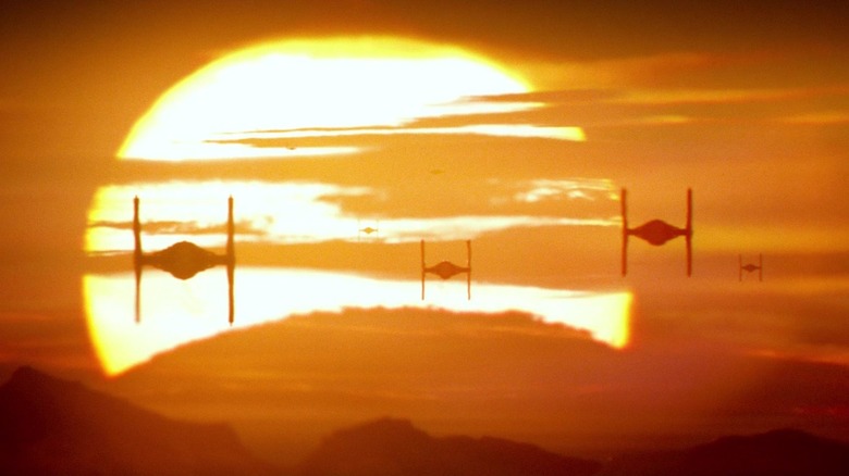 TIE fighters flying through the sky with the sun in the background in Star Wars: The Force Awakens