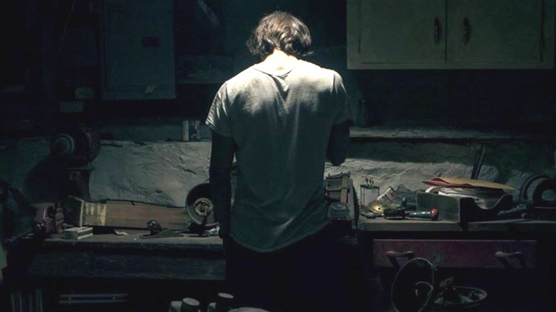 Wyatt standing in front of a work bench in 