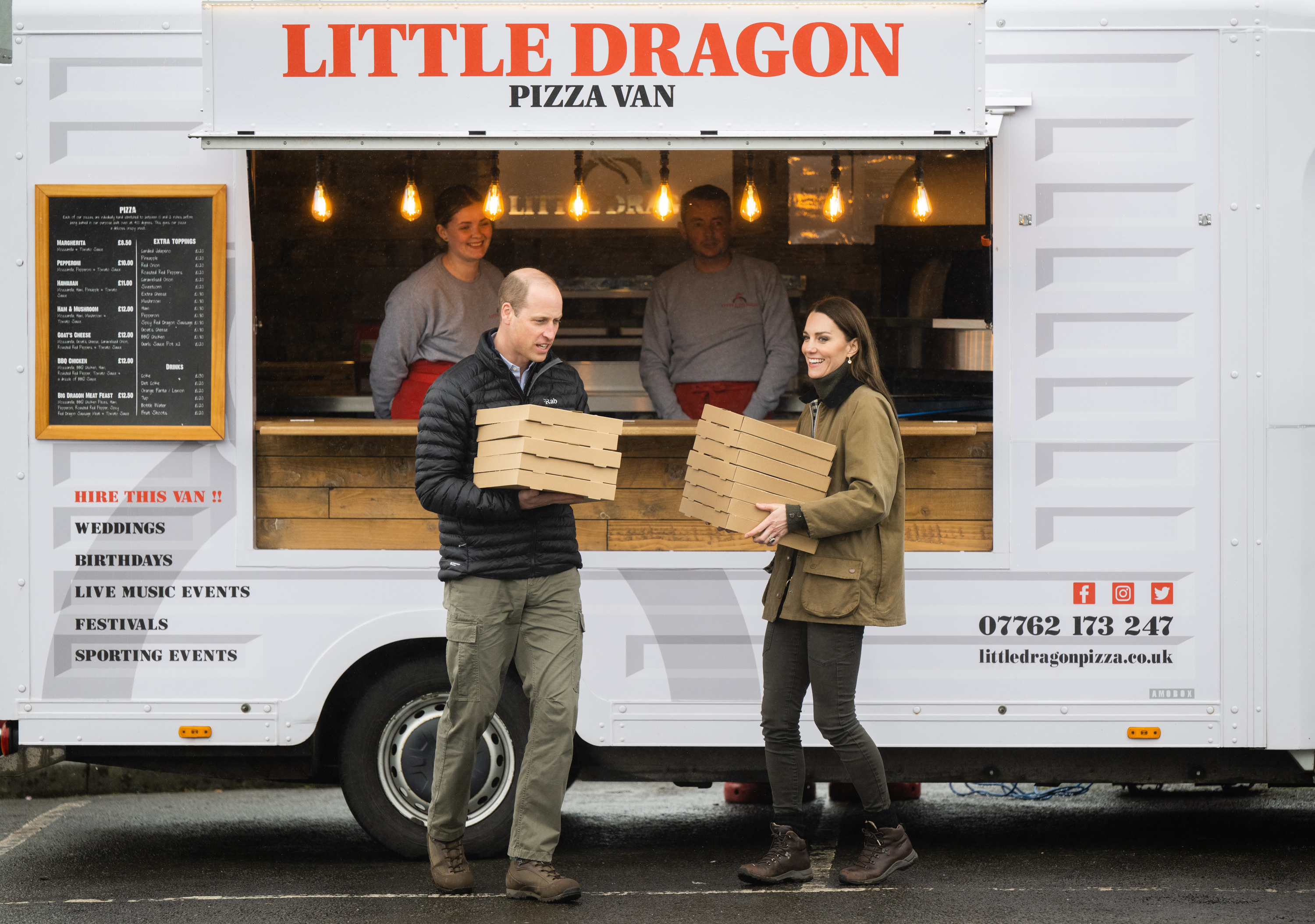 Prince William and Princess Kate holding pizza boxes leaving a food truck