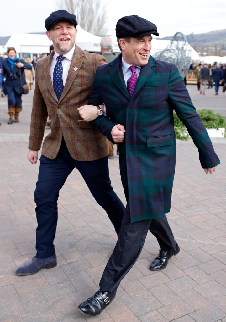 Mike Tindall and Peter Phillips walk arm-in-arm at Cheltenham