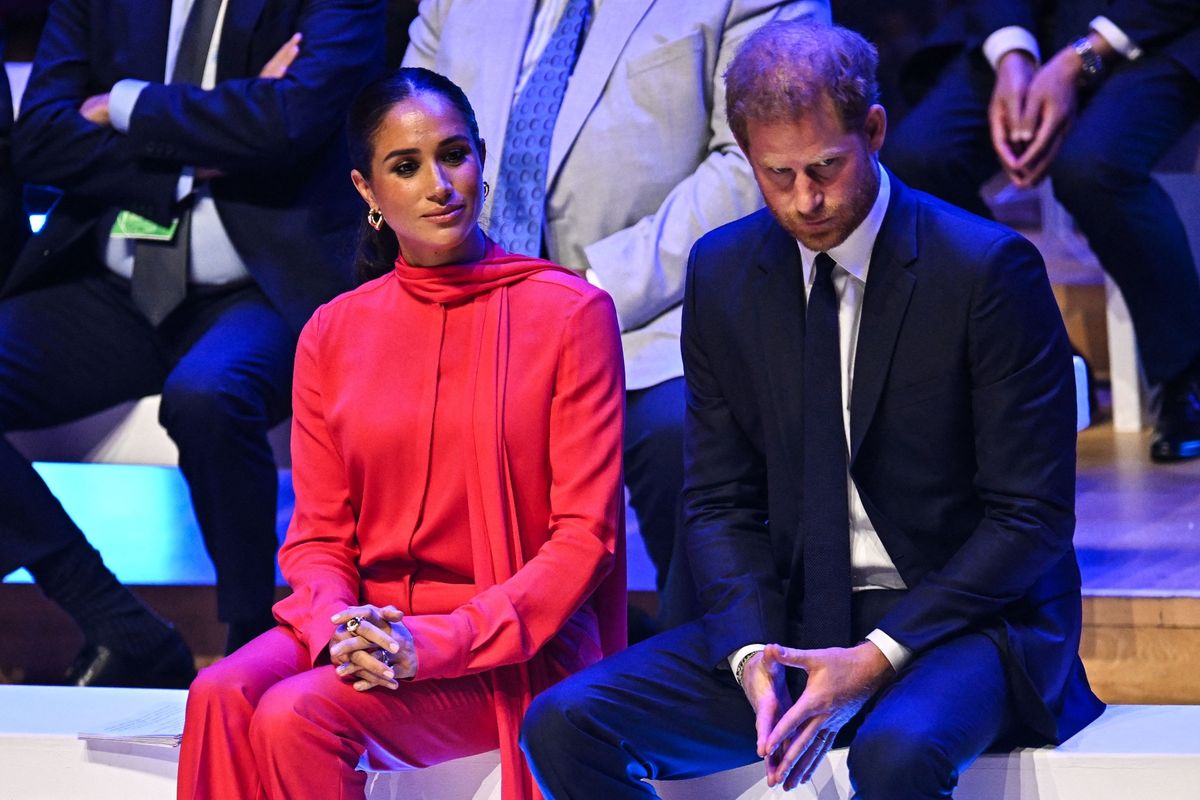 Meghan Markle, left, wearing red, and Prince Harry, right, during the One Young World conference in Manchester in September 2022