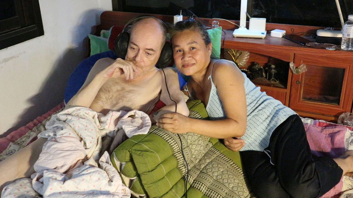 David Carey lying in bed with his wife Kanjana in bed