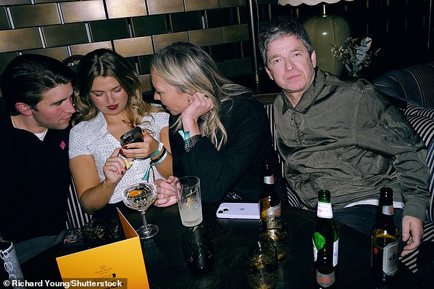 Noel Gallagher lived up to Oasis' rock and roll reputation as he boozed on Peroni until 4am in the morning at the BRITs afterparty (Noel pictured with Callum Scott Howells and Anais)