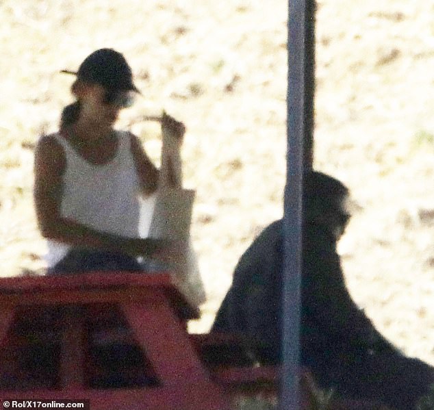 They mingled at the same red picnic table under a tent