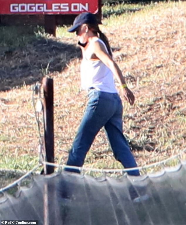 Garner wore a white tank top with faded, baggy blue denim jeans, blue sneakers and a blue Linden cap and aviator sunglasses as she carried a beige tote bag