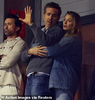 As Lively cheered on her husband's team from the stands, she was spotted wrapping her arms around his waist while standing close behind him