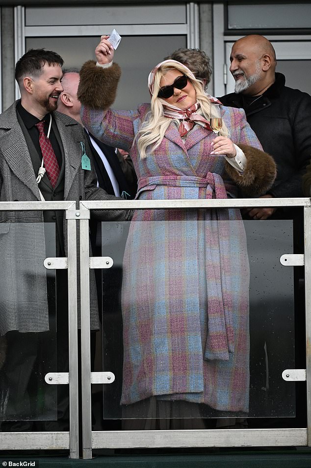 She threw her arm in the air with pure delight