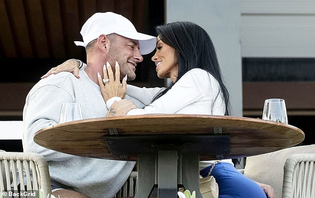 The couple shared a steamy smooch with the I'm A Celeb star lovingly caressing her husband's face and showing off her dazzling diamond wedding ring