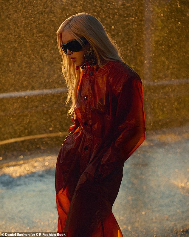 Meanwhile, in another shot, the singer looked effortlessly stylish in a satin red coat, oversized shades, and statement drop earrings all from Saint Laurent