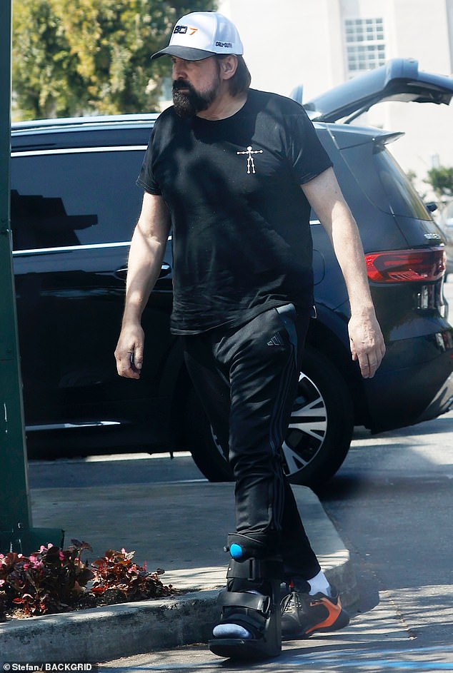 A brace was seen on his left leg as he made his way through a crowded parking lot during the lowkey excursion
