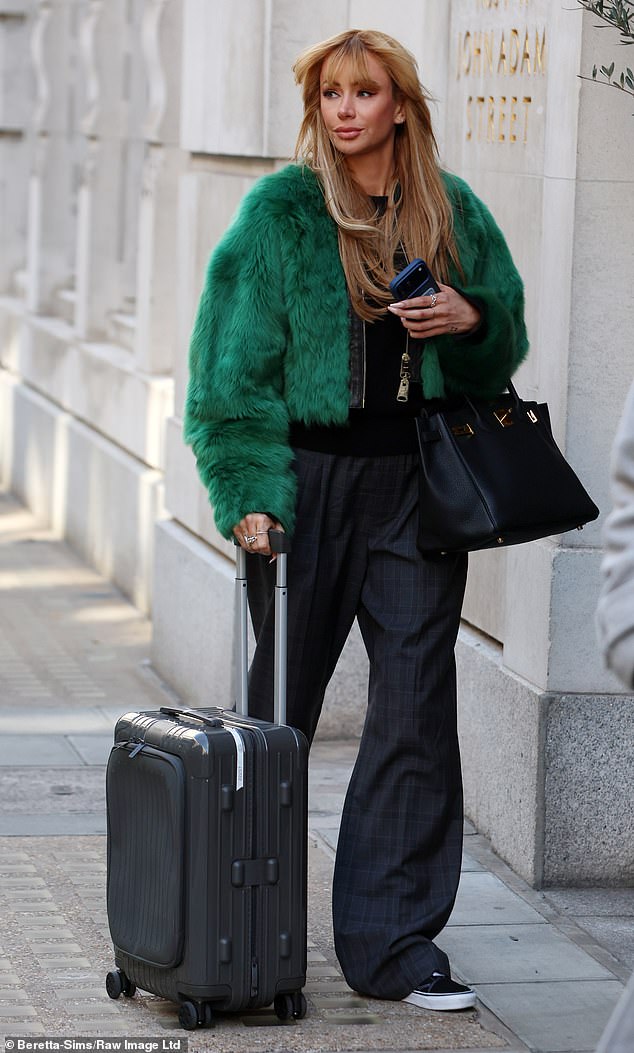 On Thursday, Olivia was the epitome of chic was she was seen arriving to record her podcast in a striking faux fur green jacket which was layered over a dark sweater and trousers