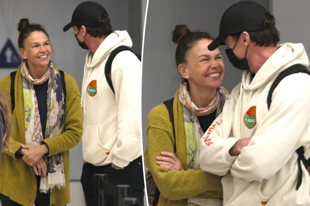Hugh Jackman and Sutton Foster look more in love than ever while arriving at LAX