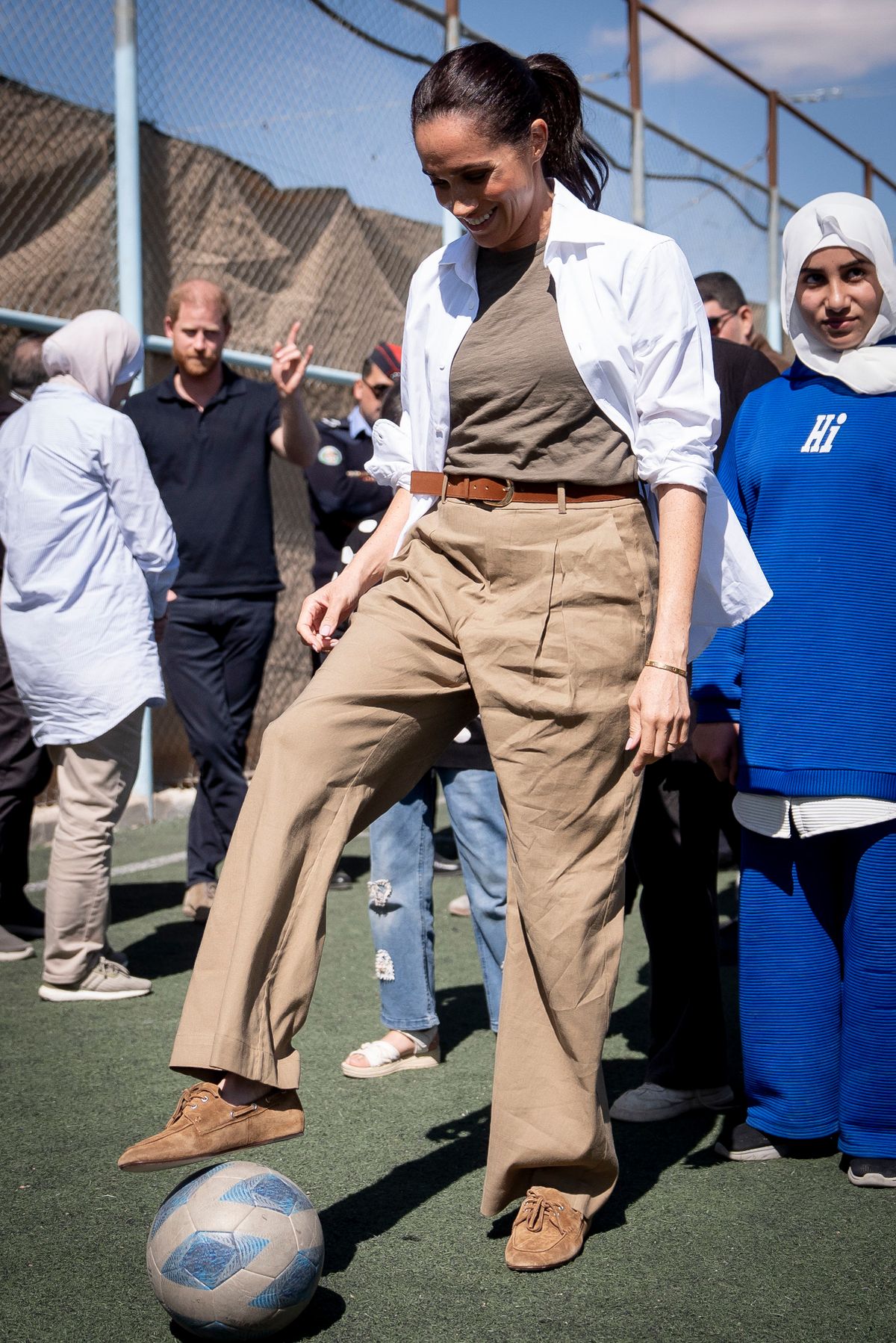 Meghan Markle kicking a football during visit to Jordan