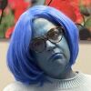 Left: The Inside Out character Sadness. Right: Clinical social worker Kristi Zybulewski dressed up as Sadness for Halloween with blue face and blue hair.