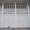 A person walks a dog in front of the Kennedy Center in Washington, D.C., on Jan. 10, 2026.