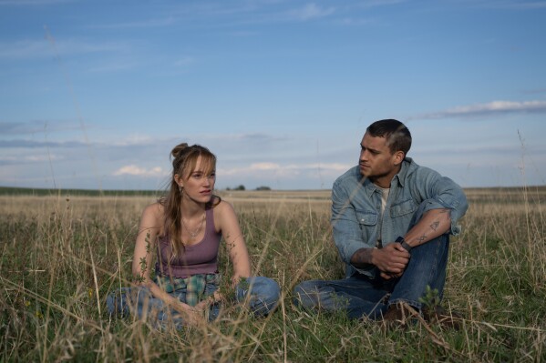 This image released by Universal Pictures shows Maika Monroe, left, and Tyriq Withers in a scene from "Reminders of Him." (Michelle Faye/Universal Pictures via AP)
