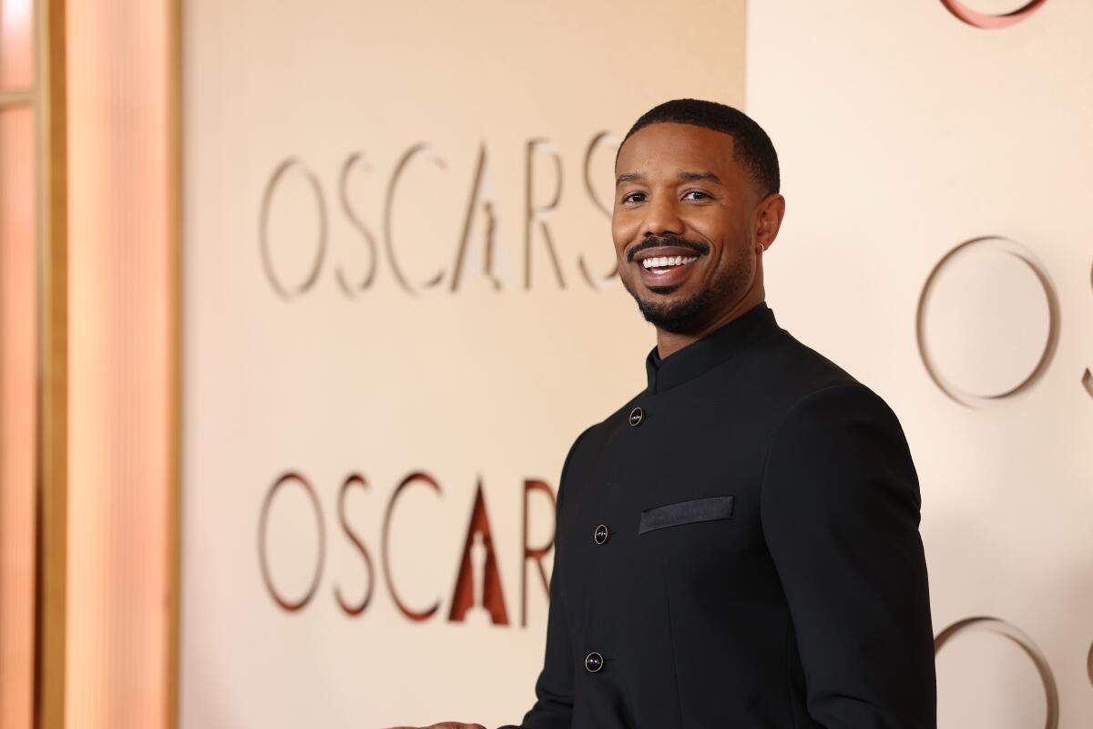 Michael B. Jordan smiles at the camera as he arrives on the red carpet at the 98th Annual Academy Awards 