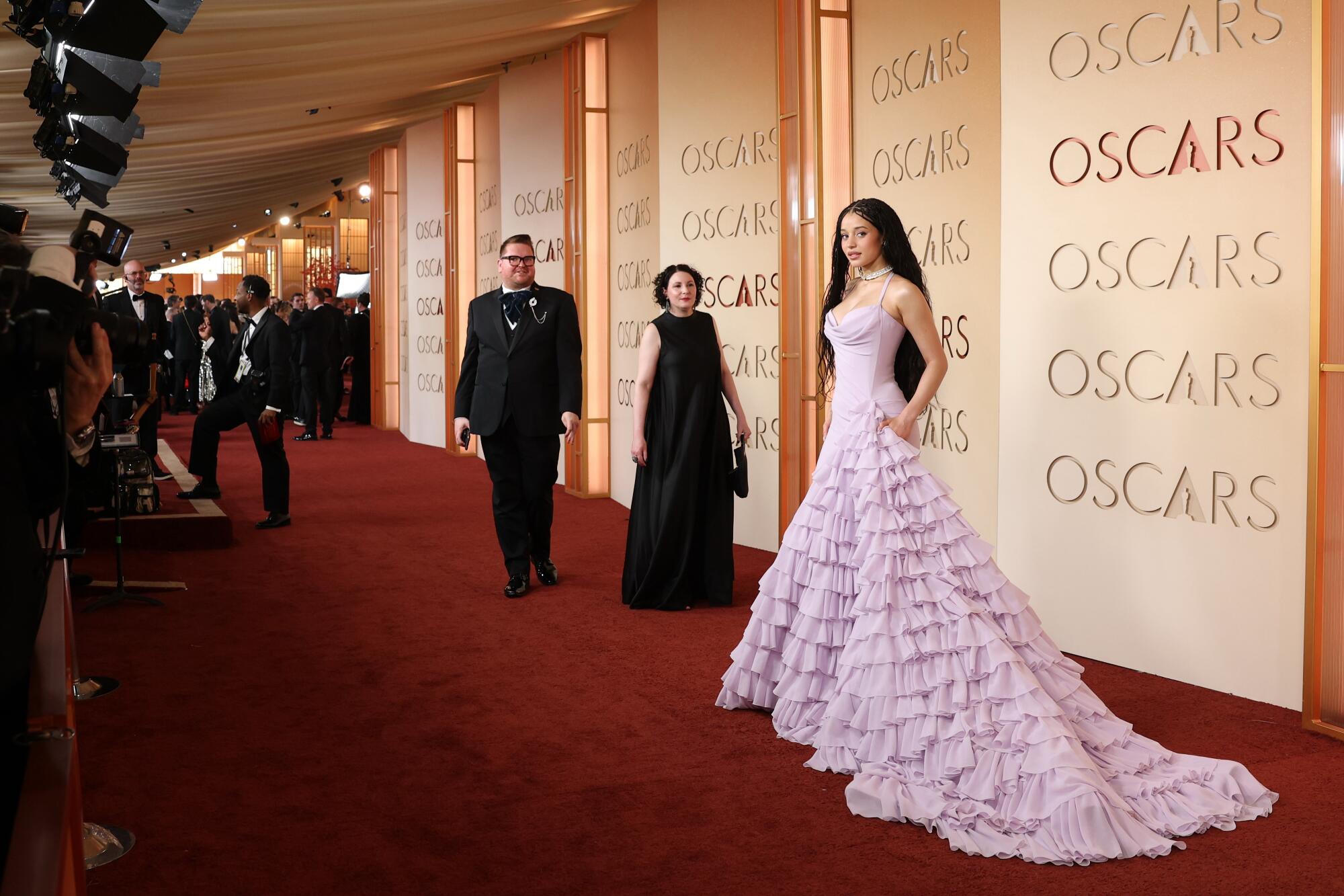 Chase Infiniti wears a long ruffled lilac gown on the red carpet at the 98th Annual Academy Awards 