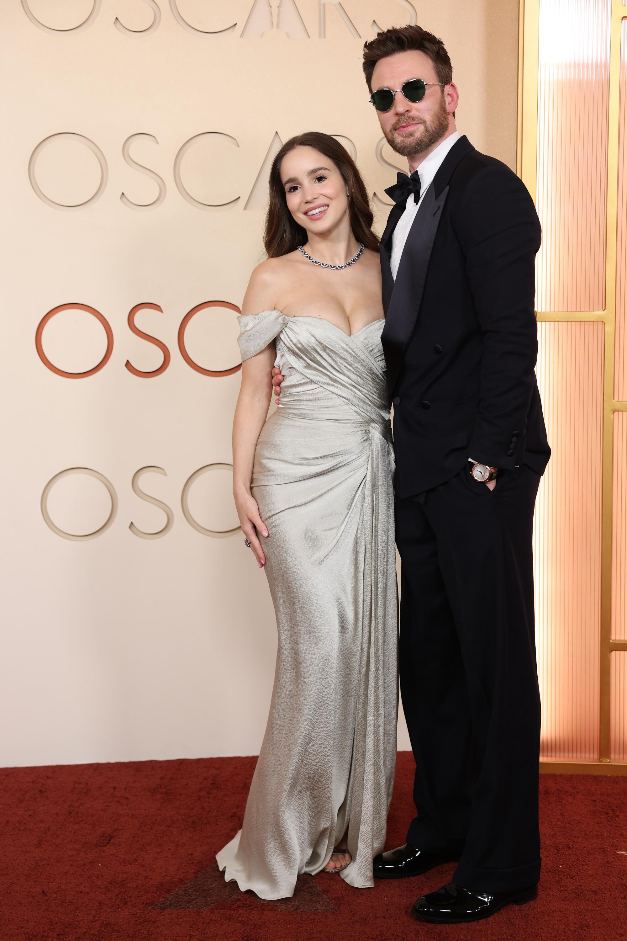 Alba Baptista and Chris Evans pose on the red carpet.
