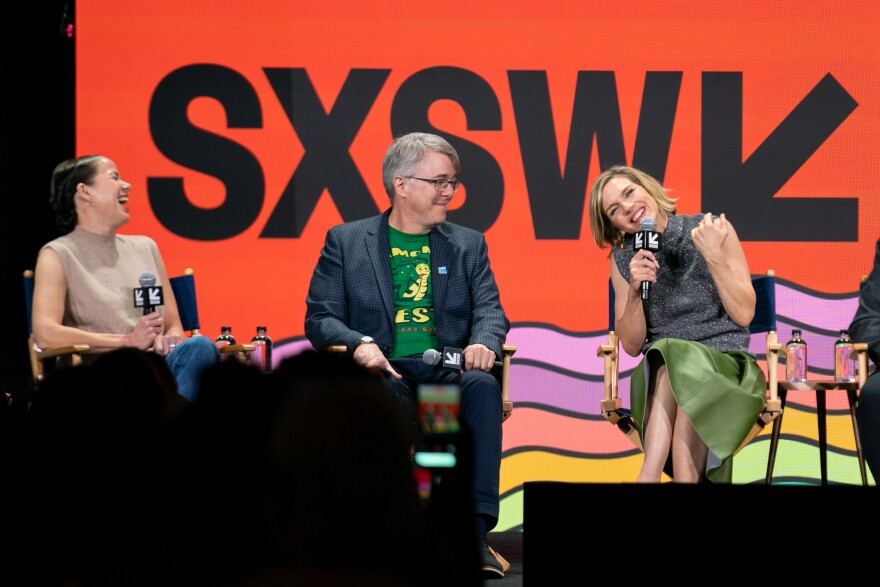 From left, Sony Pictures Television president Katherine Pope laughs with show runner Vince Gilligan and actor Rhea Seehorn on a stage in front of a SXSW logo.