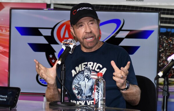 Chuck Norris speaks to reporters during a media availability before the NASCAR Sprint Cup Series auto race at Texas Motor Speedway in Fort Worth, Texas, on Nov. 6, 2016. (AP Photo/Larry Papke, File)