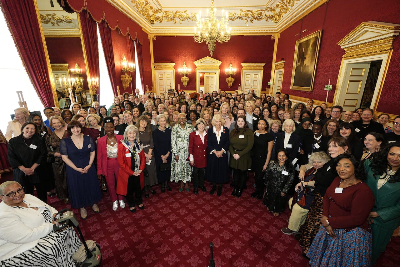A large group of women are shown in a large room.