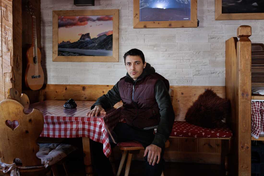 Riccardo Fiore, grandson of Olympic gold medalist Yvonne Rüegg, poses inside his family's alpine lodge in the Dolomites.