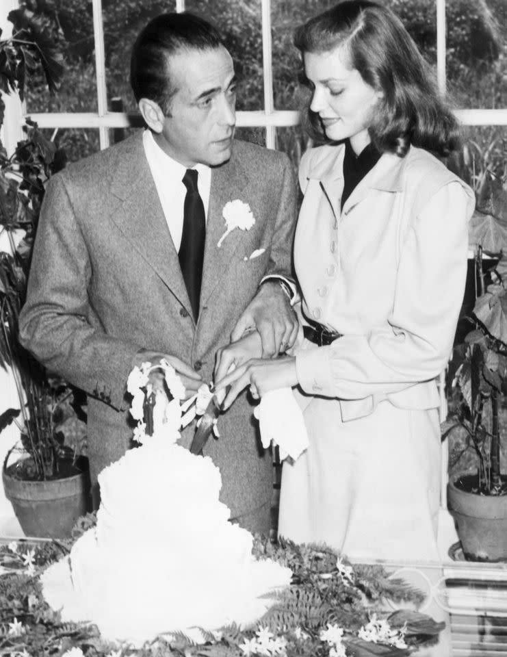 Humphrey Bogart and Lauren Bacall cut the cake at their wedding on May 21, 1945Credit: Hulton Archive/Getty