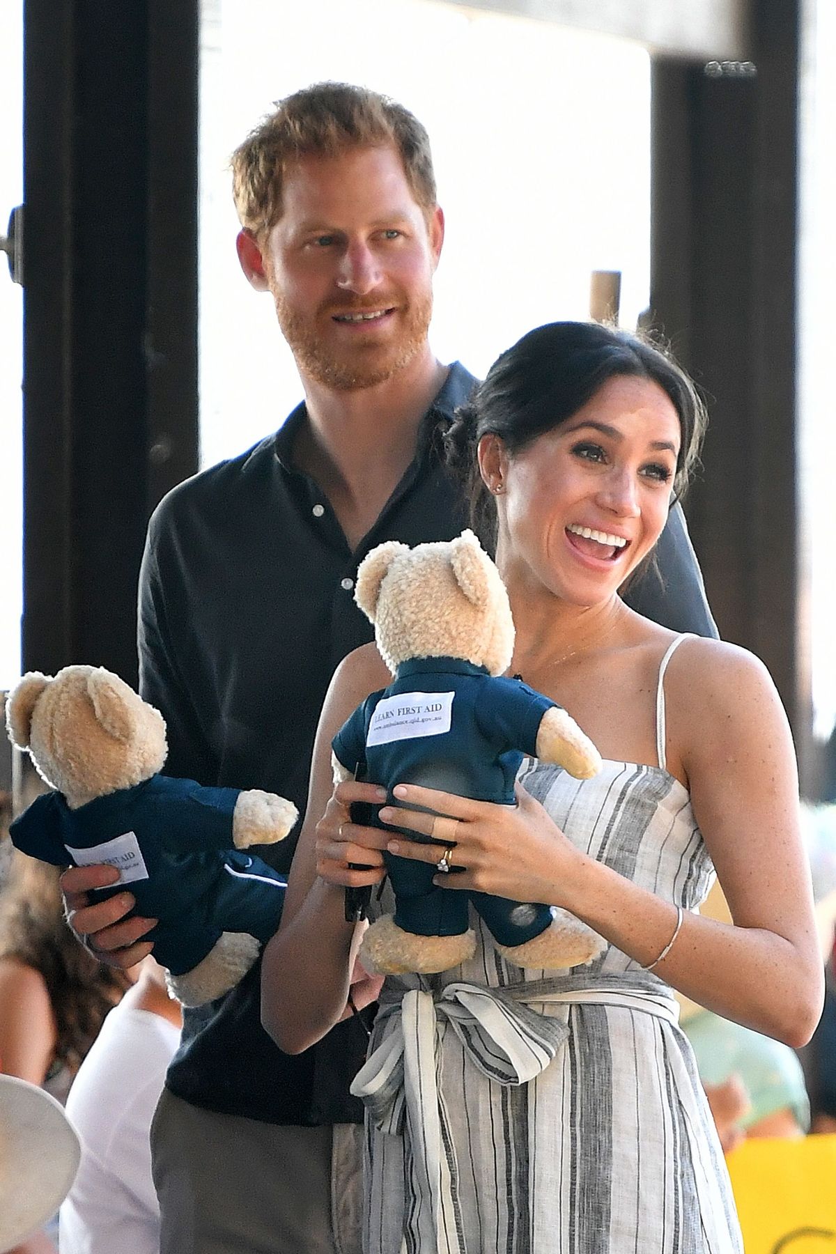 Prince Harry and his wife Meghan, the Duchess of Sussex hold stuffed toys during a meet-the-people walk at Kingfisher Bay Resort on Fraser Island on October 22, 2018.