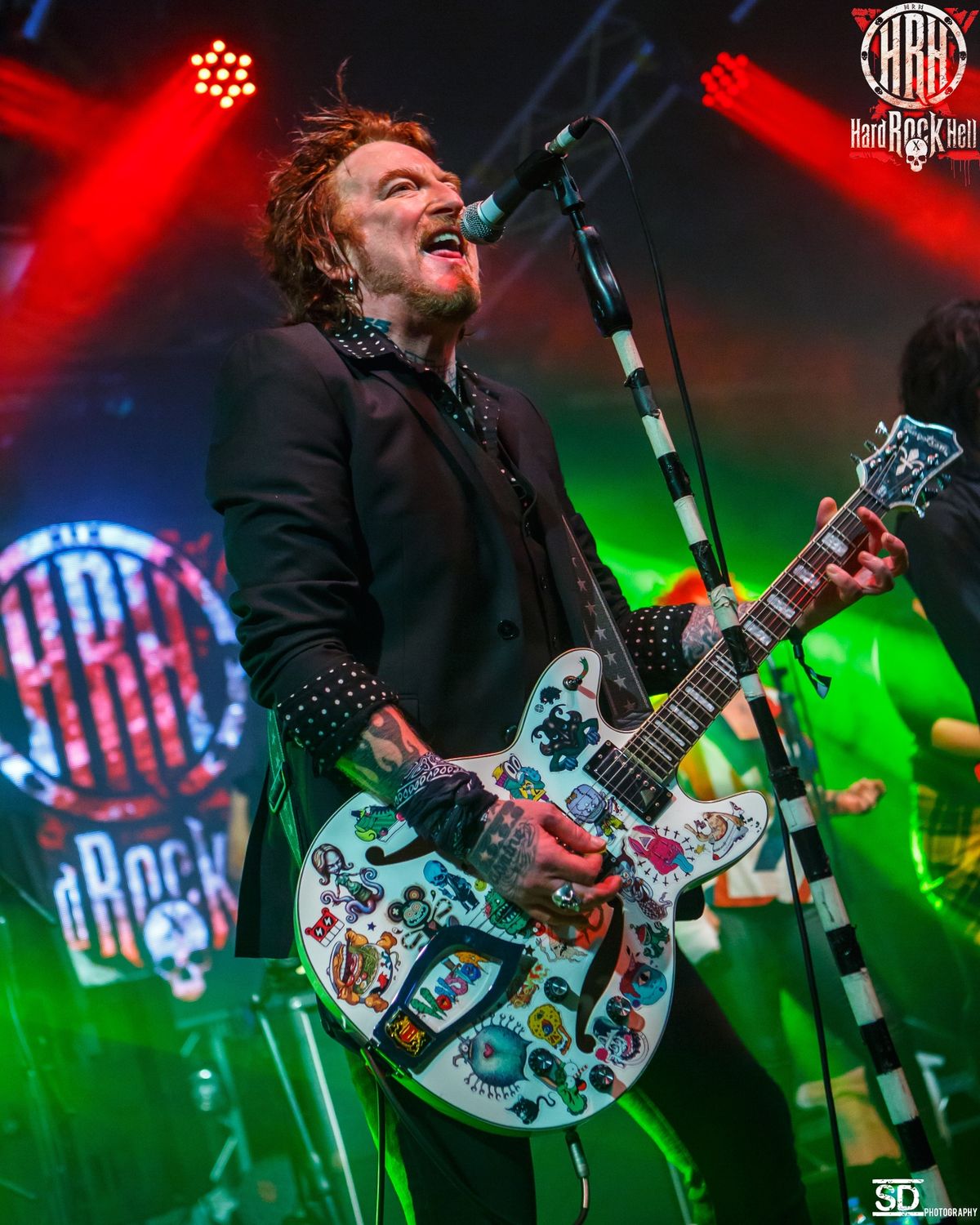 ginger wildheart singing on stage with guitar