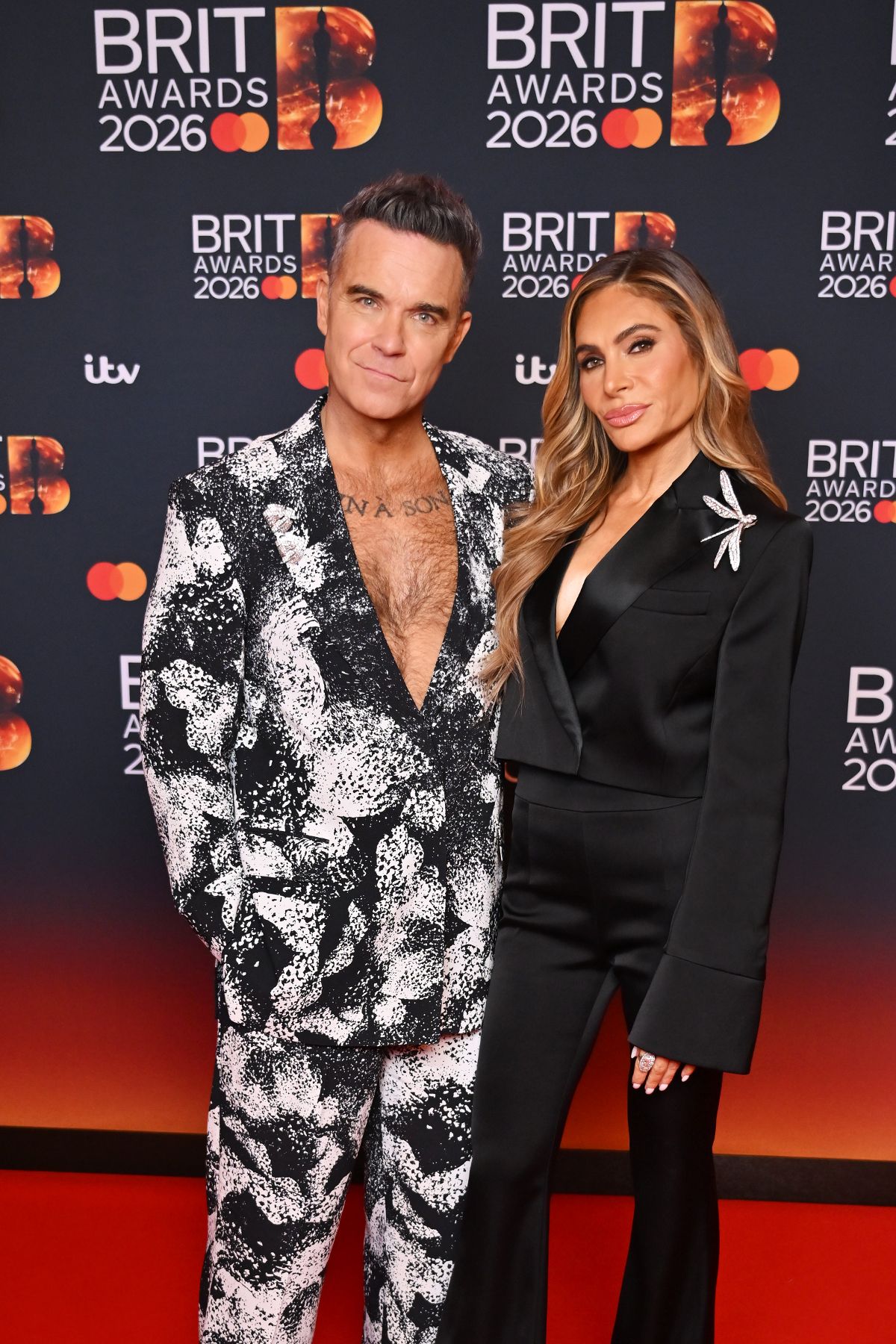 Robbie also posed on the red carpet with his wife Ayda Field