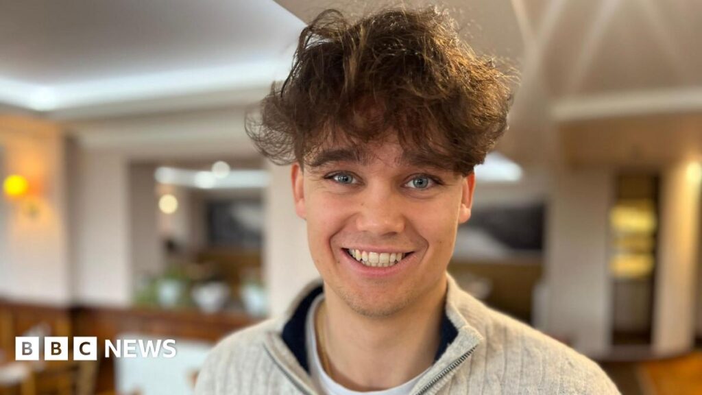 A man with brown hair, smiling