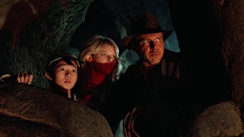 Short Round, Willie, and Indy peering over a ceremony in Indiana Jones and the Temple of Doom